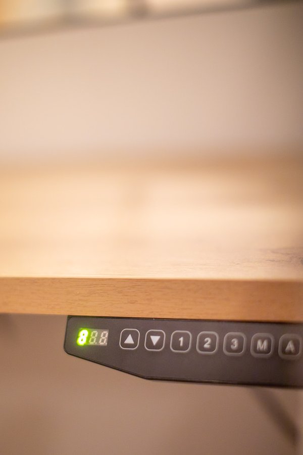 Height-adjustable desk control panel